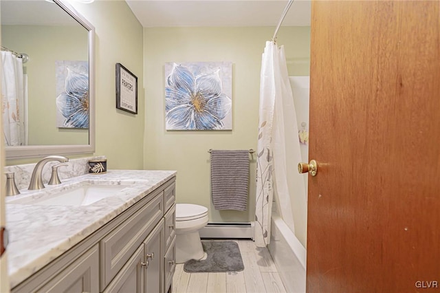 full bathroom with toilet, hardwood / wood-style flooring, baseboard heating, vanity, and shower / bath combination with curtain