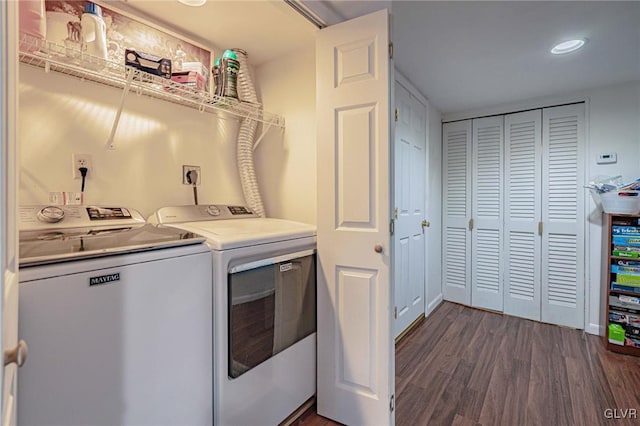 laundry room with dark hardwood / wood-style flooring and washing machine and dryer