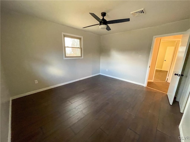 unfurnished room with dark hardwood / wood-style flooring and ceiling fan