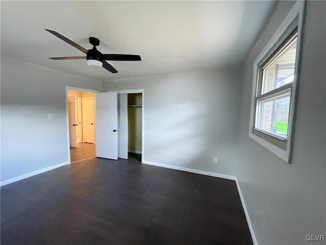 unfurnished bedroom with dark wood-type flooring, ceiling fan, and a closet