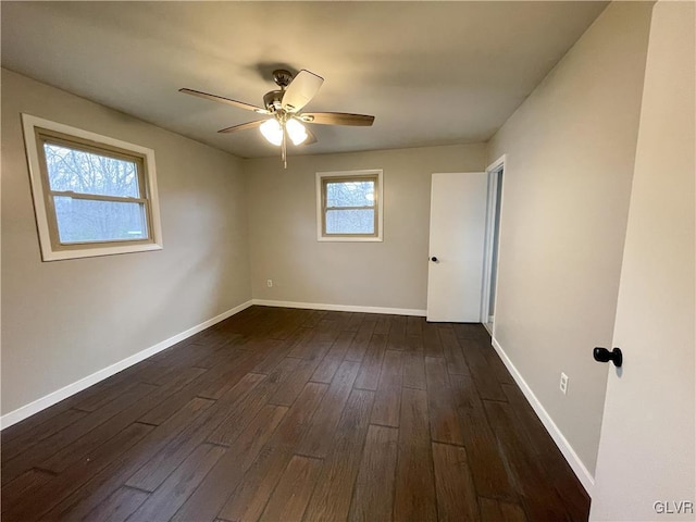 spare room featuring dark wood-type flooring and ceiling fan