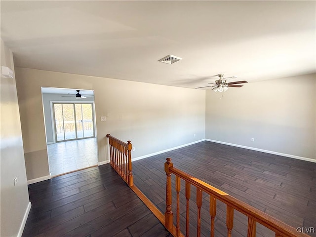 unfurnished room with ceiling fan and dark hardwood / wood-style floors