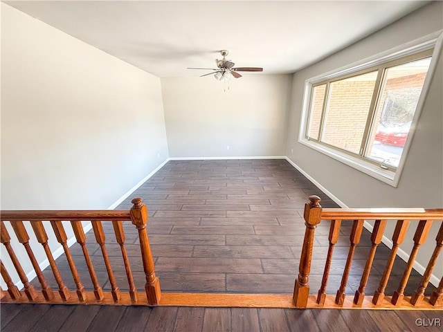 staircase featuring wood-type flooring and ceiling fan