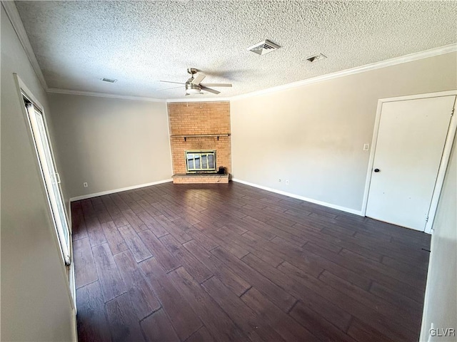 unfurnished living room with ceiling fan, dark hardwood / wood-style floors, a fireplace, ornamental molding, and a textured ceiling