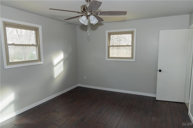 unfurnished room featuring dark hardwood / wood-style floors, a wealth of natural light, and ceiling fan