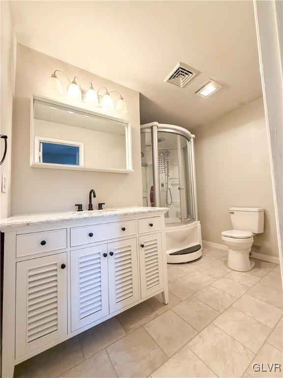 bathroom with vanity, toilet, and walk in shower