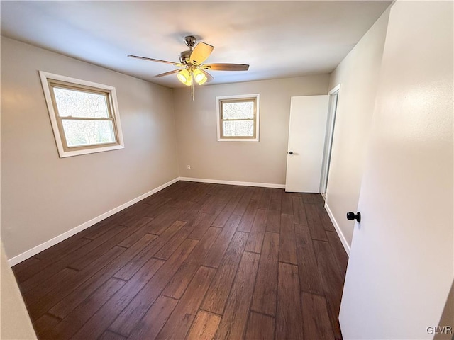 empty room with ceiling fan and dark hardwood / wood-style floors