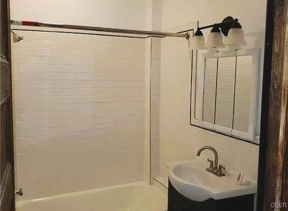 bathroom featuring vanity and tiled shower / bath combo