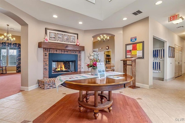 interior space featuring an inviting chandelier and a fireplace