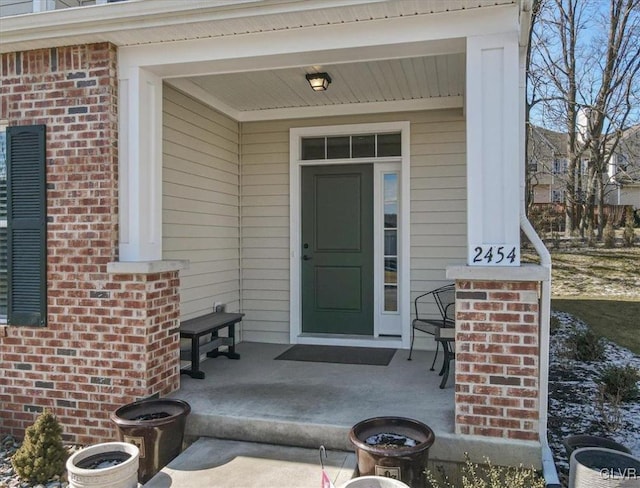 view of exterior entry featuring a porch