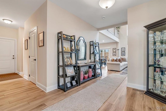 corridor with light hardwood / wood-style flooring