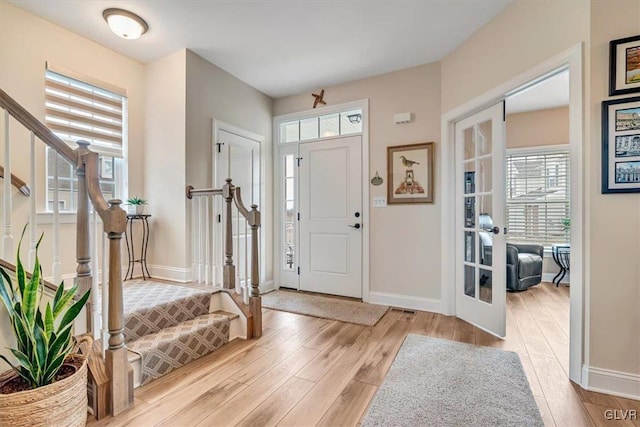 entrance foyer with light wood-type flooring and french doors