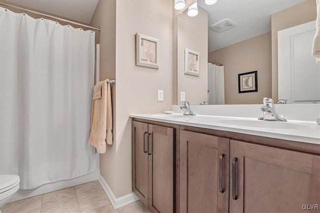 bathroom with vanity, tile patterned floors, and toilet