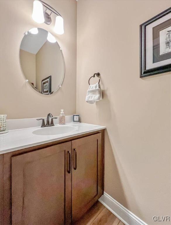 bathroom with hardwood / wood-style flooring and vanity