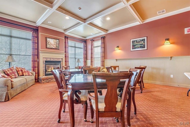 dining room with coffered ceiling, a fireplace, carpet flooring, and beam ceiling