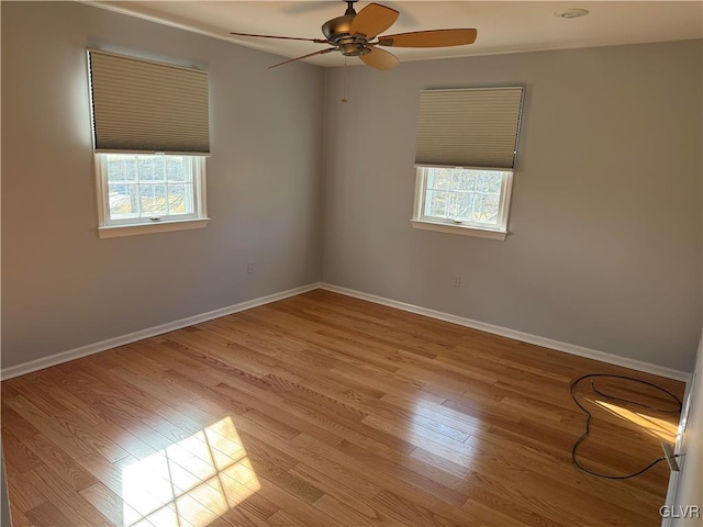 unfurnished room featuring plenty of natural light, light hardwood / wood-style floors, and ceiling fan