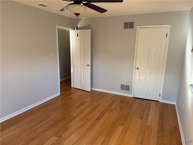 unfurnished bedroom featuring hardwood / wood-style flooring and ceiling fan