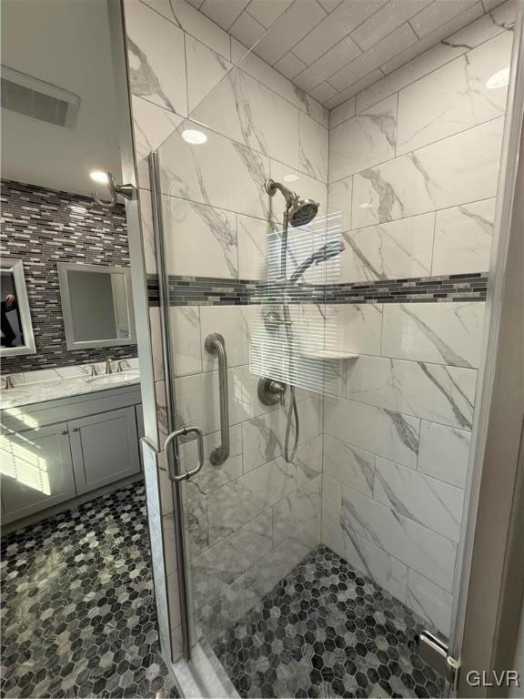 bathroom featuring an enclosed shower and vanity