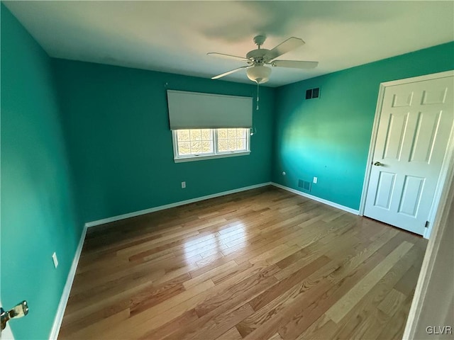 unfurnished room with ceiling fan and light wood-type flooring