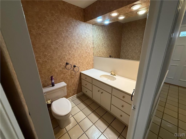 bathroom with tile patterned flooring, vanity, and toilet