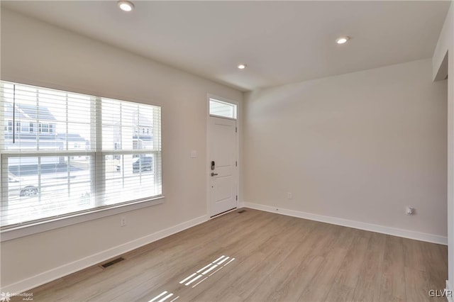 foyer entrance with light hardwood / wood-style flooring