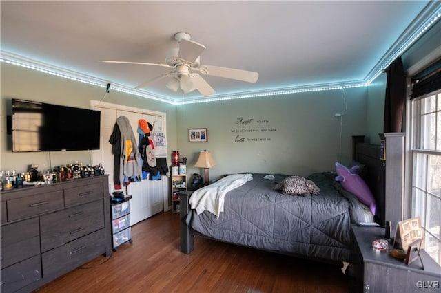 bedroom with crown molding, ceiling fan, and wood-type flooring