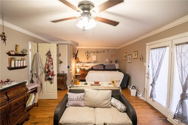 bedroom with hardwood / wood-style flooring, ceiling fan, and ornamental molding