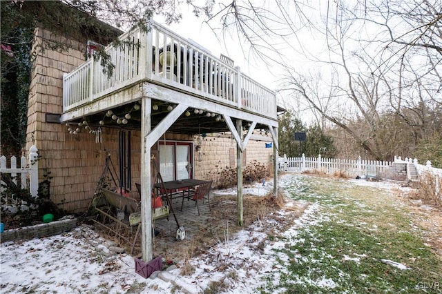 yard covered in snow featuring a wooden deck