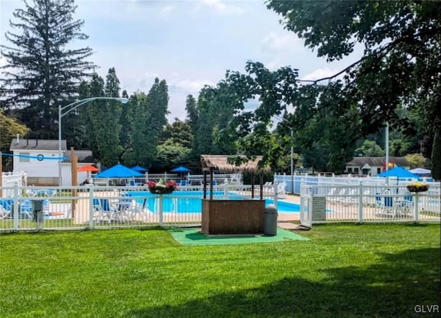 view of swimming pool with a lawn