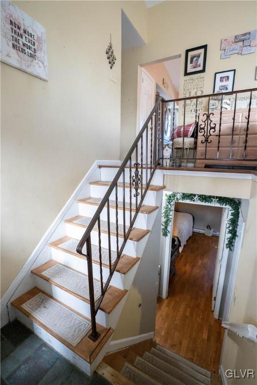 stairs with hardwood / wood-style floors