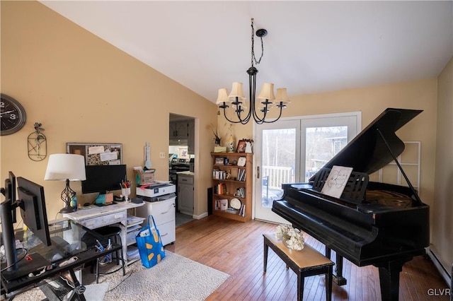 miscellaneous room featuring an inviting chandelier, vaulted ceiling, and light hardwood / wood-style floors