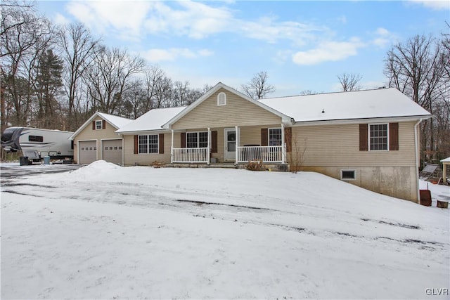 single story home with a garage and covered porch