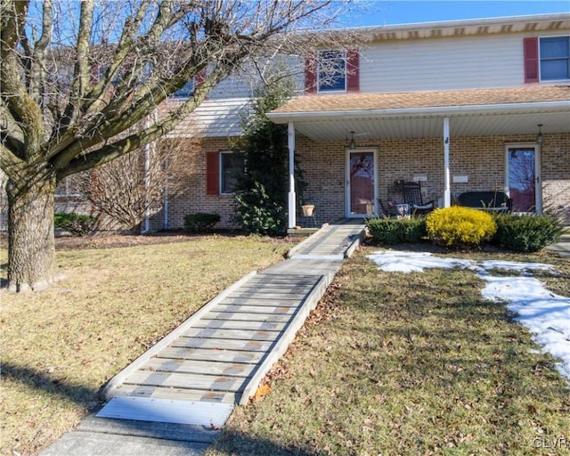 view of front of property with a porch and a front lawn