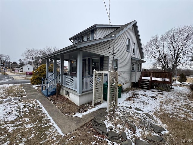 view of snowy exterior with a porch