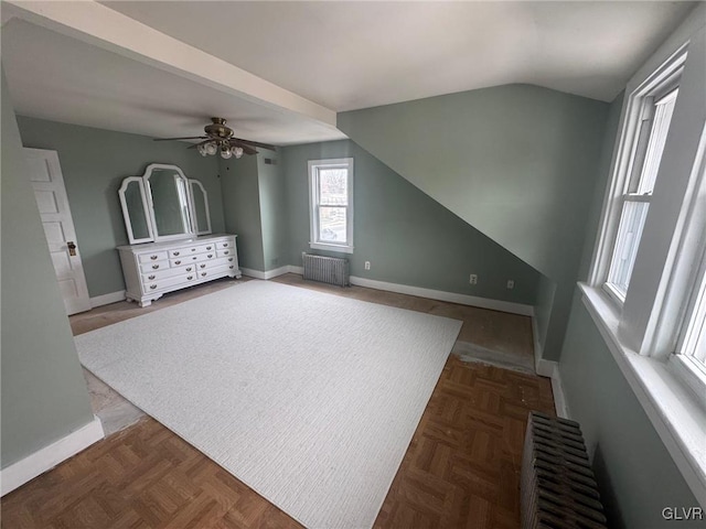 bonus room featuring ceiling fan, radiator heating unit, vaulted ceiling, and dark parquet floors