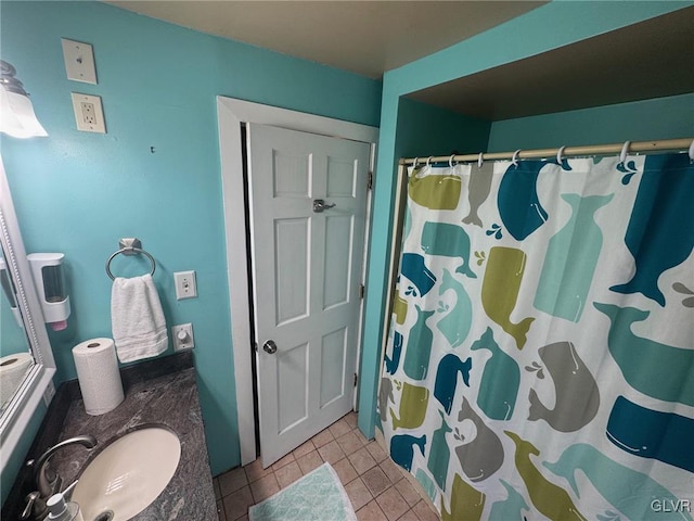 bathroom with tile patterned flooring, sink, and a shower with curtain