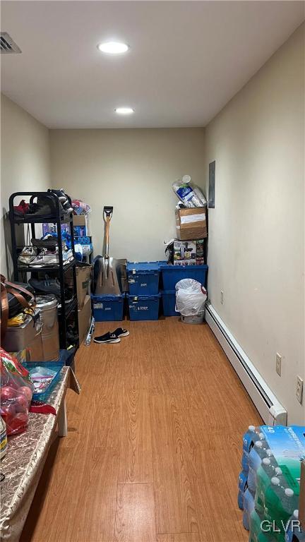 storage room with a baseboard heating unit