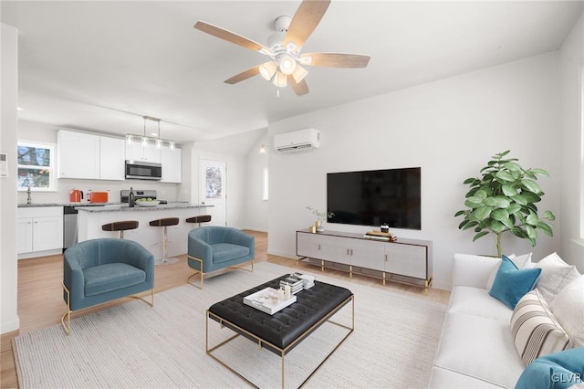 living room featuring vaulted ceiling, a wall mounted air conditioner, ceiling fan, and light hardwood / wood-style flooring