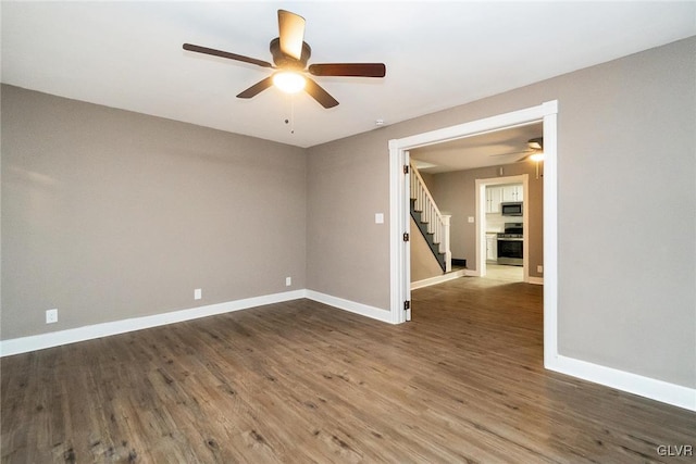 unfurnished room with ceiling fan and dark hardwood / wood-style floors