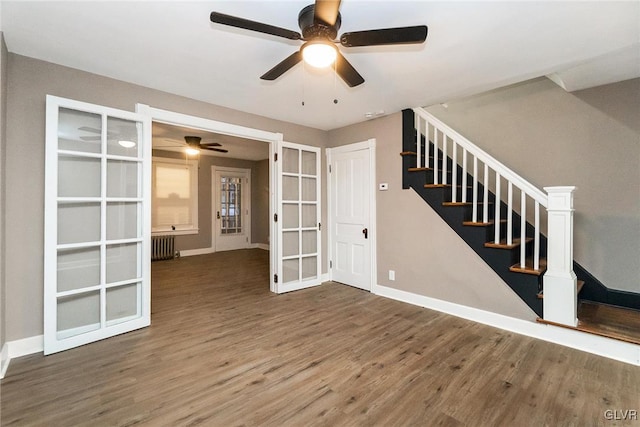 interior space with hardwood / wood-style flooring, radiator heating unit, french doors, and ceiling fan