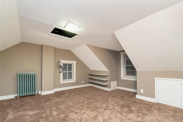 bonus room featuring carpet floors, radiator heating unit, and vaulted ceiling