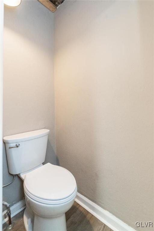 bathroom featuring wood-type flooring and toilet