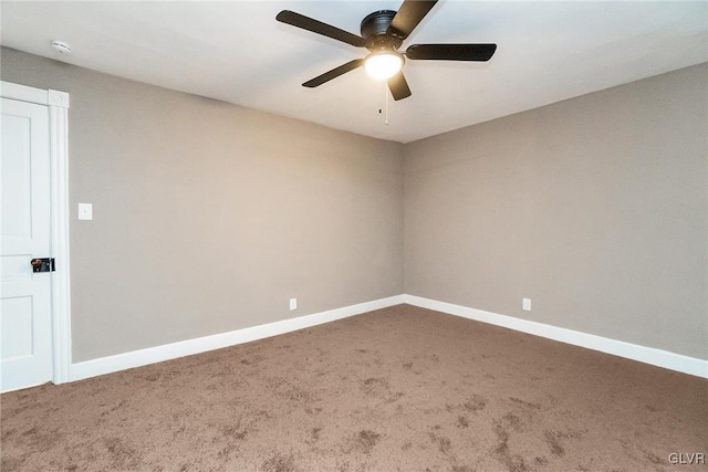 carpeted spare room featuring ceiling fan