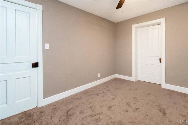 empty room with ceiling fan and carpet flooring