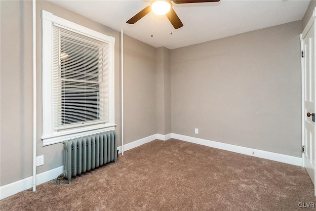 carpeted empty room with radiator and ceiling fan