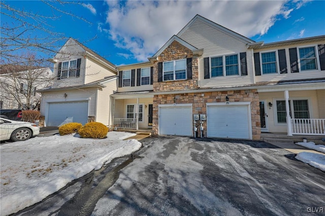 multi unit property with a garage and a porch