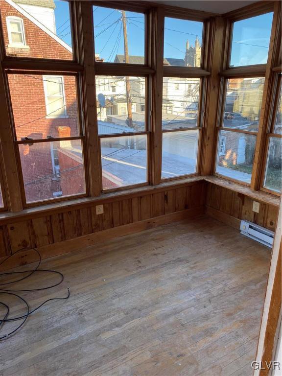 unfurnished sunroom with a baseboard radiator