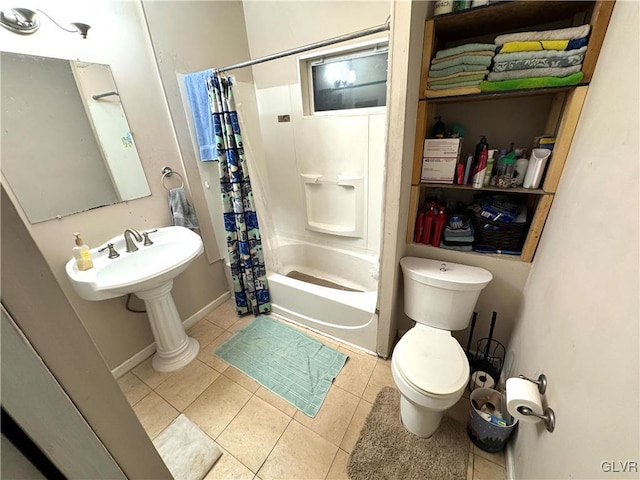 full bath with toilet, shower / bath combo, a sink, baseboards, and tile patterned floors