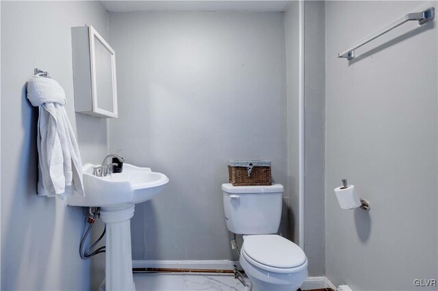 349 Carlton Rd, Paradise Twp, PA 18344 - half bathroom with toilet, baseboards, and marble look tile flooring