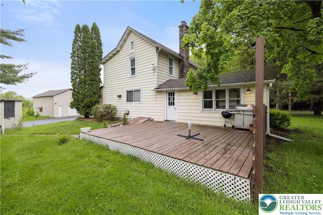 349 Carlton Rd, Paradise Twp, PA 18344 - rear view of property with a chimney, a wooden deck, and a lawn